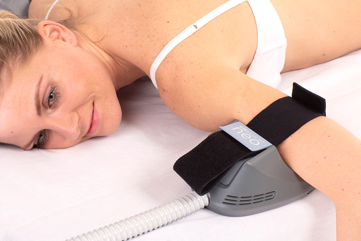 Emsculpt Neo product being used on a female's biceps