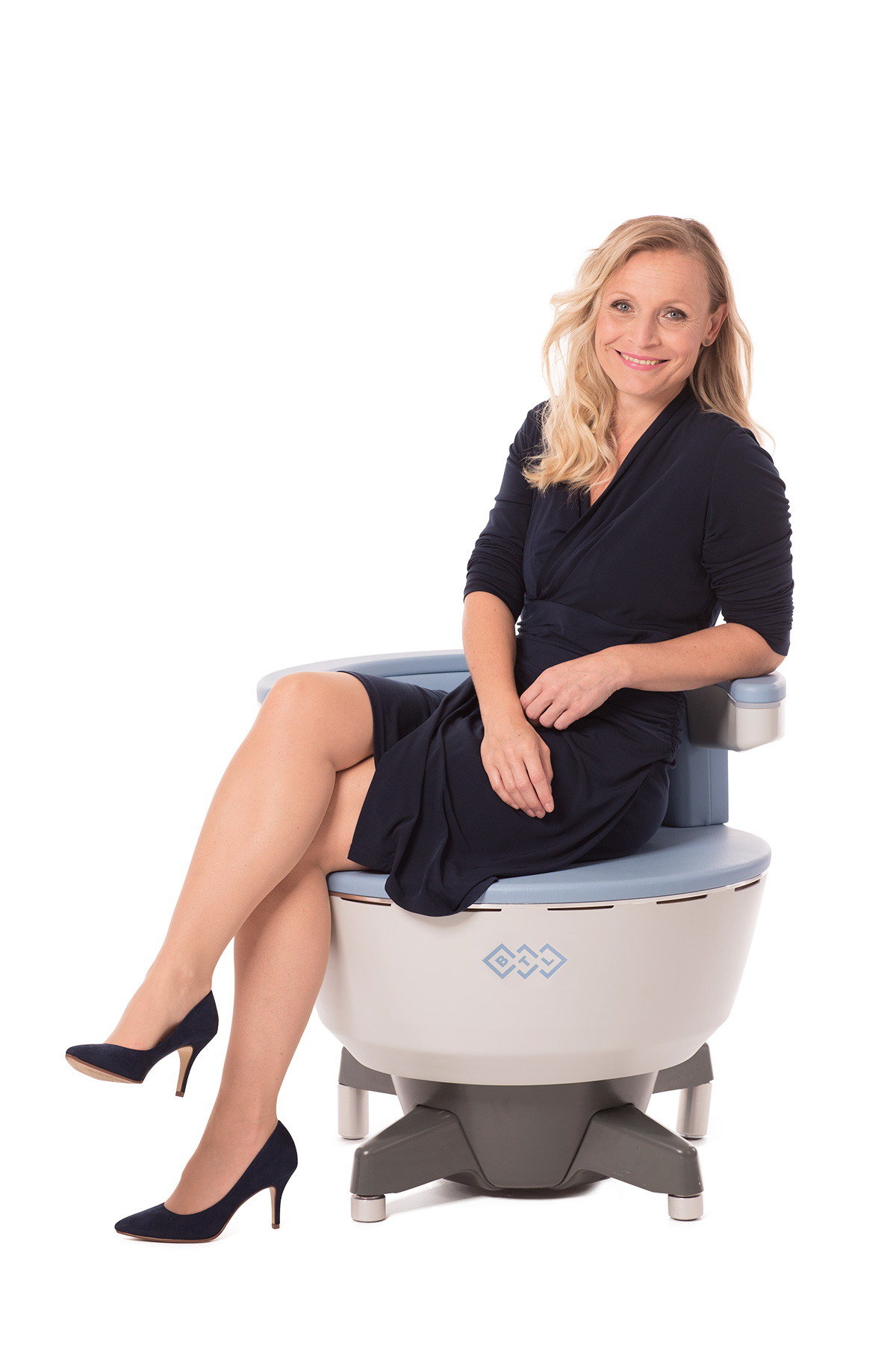 Female sitting and using the Emsella chair