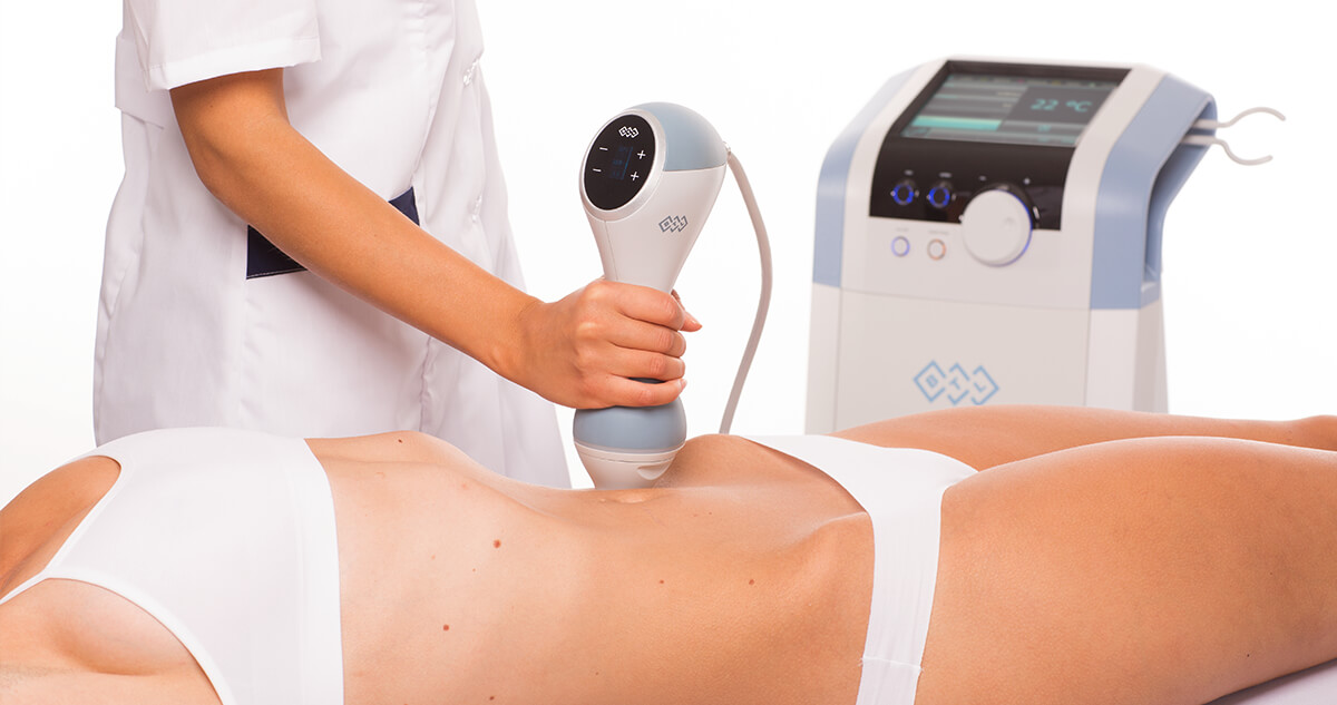 Emtone product being used on the back of a female client\'s stomach