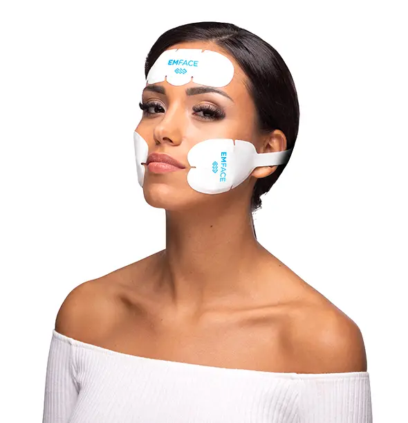 A model wearing EMFACE facial treatment