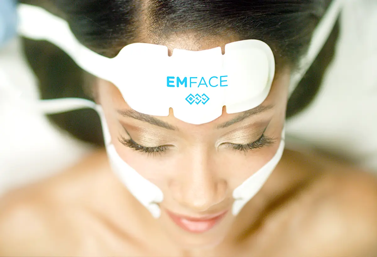 A relaxed female lying down using the EMFACE machine.