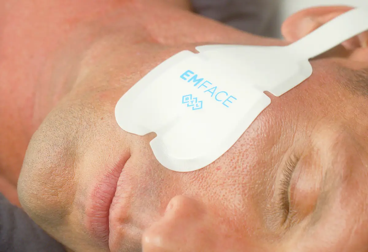 A male using the Emface machine